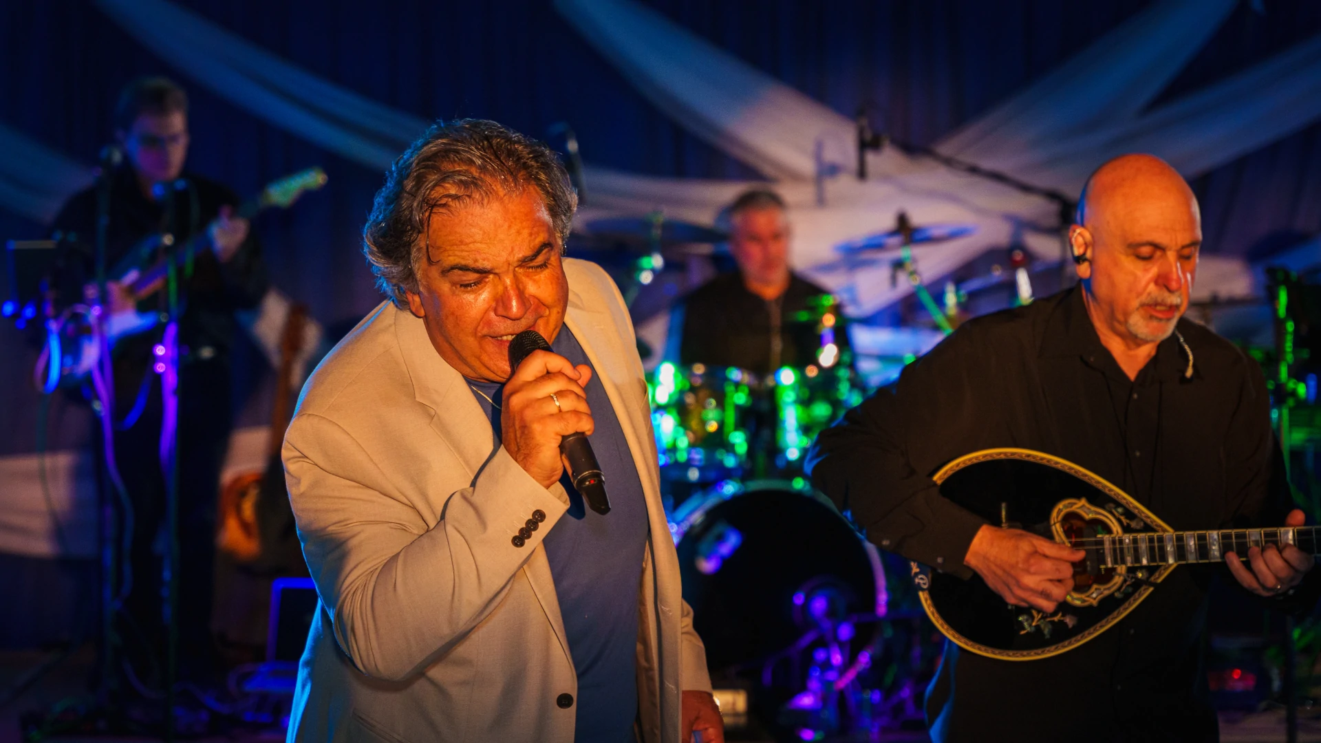 Orfeas Band performing at a Greek festival under stage lights
